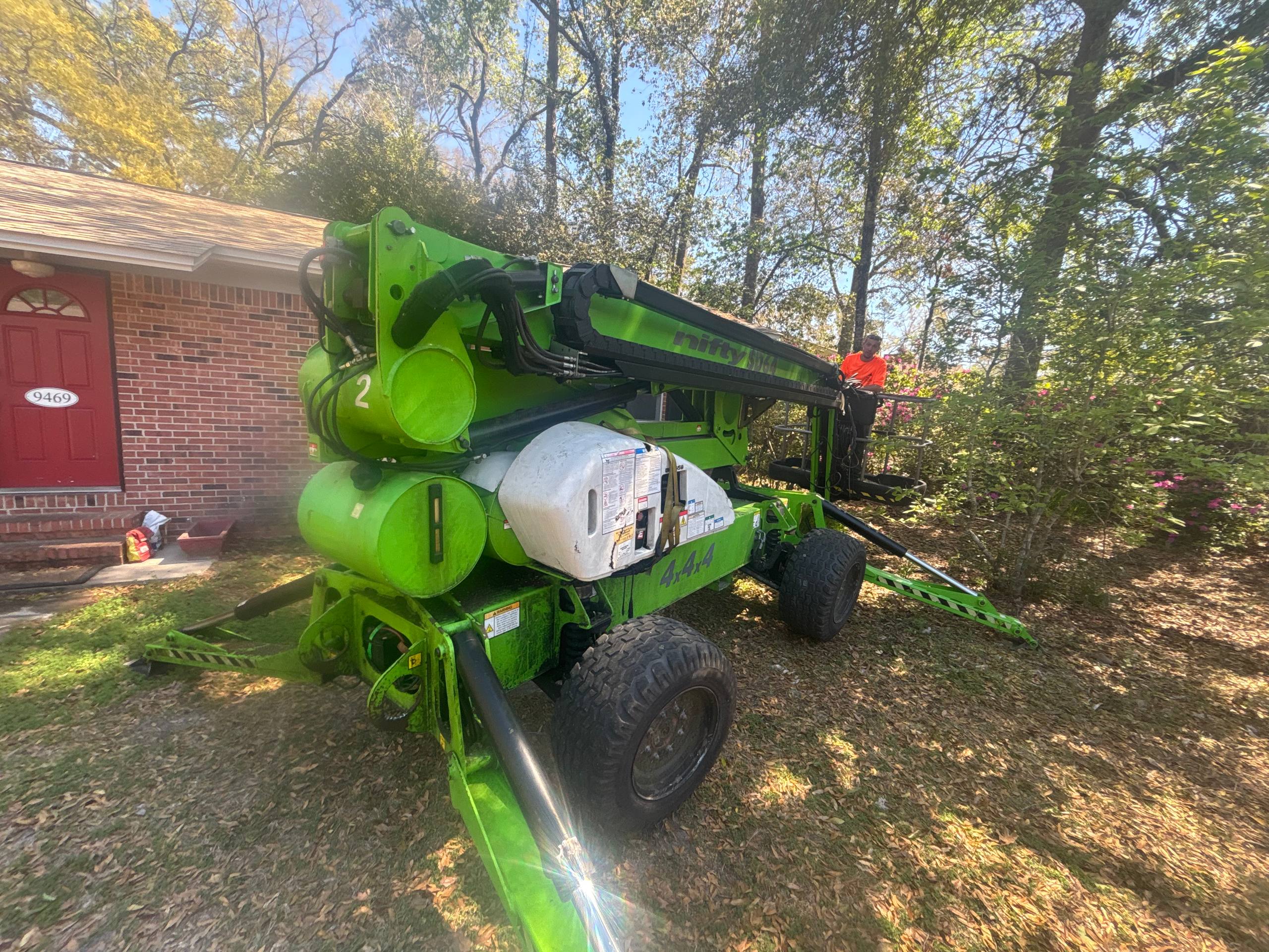 Nifty-Lift boom lift at residential property for tree service work in Tallahassee
